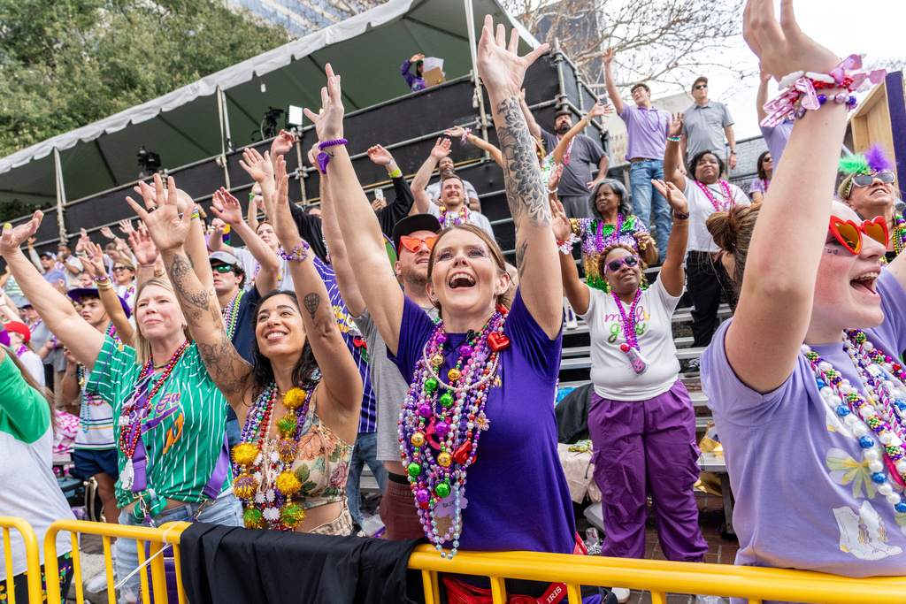 Attendees march during the annual Krewe of Iris parade during the Mardi Gras season on Saturday, Feb. 14, 2026, in New Orleans. (Photo by Amy Harris/Invision/AP)