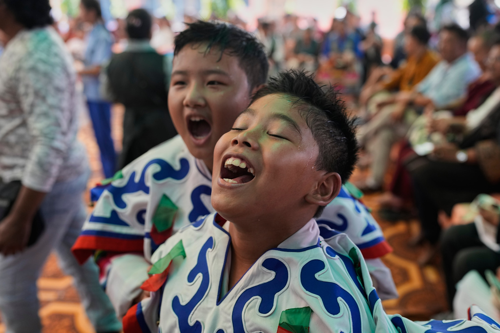 Exiled Tibetan children stand in front of a fan to cool off after performing during celebrations marking the birthday of Tibetan spiritual leader the Dalai Lama at a Tibetan school in New Delhi, India, Monday, July 6, 2026. (AP Photo/Manish Swarup)