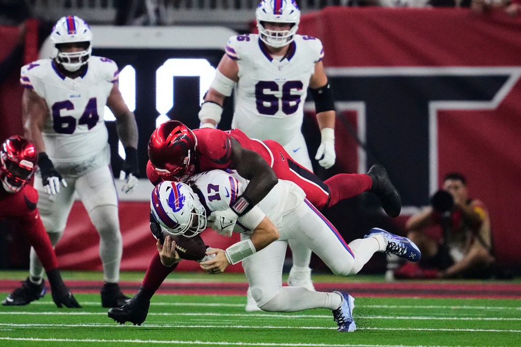 Buffalo Bills quarterback Josh Allen (17) is sacked by Houston Texans defensive end Will Anderson Jr. (51) in the first half of an NFL football game Thursday, Nov. 20, 2025, in Houston. (AP Photo/Ashley Landis)