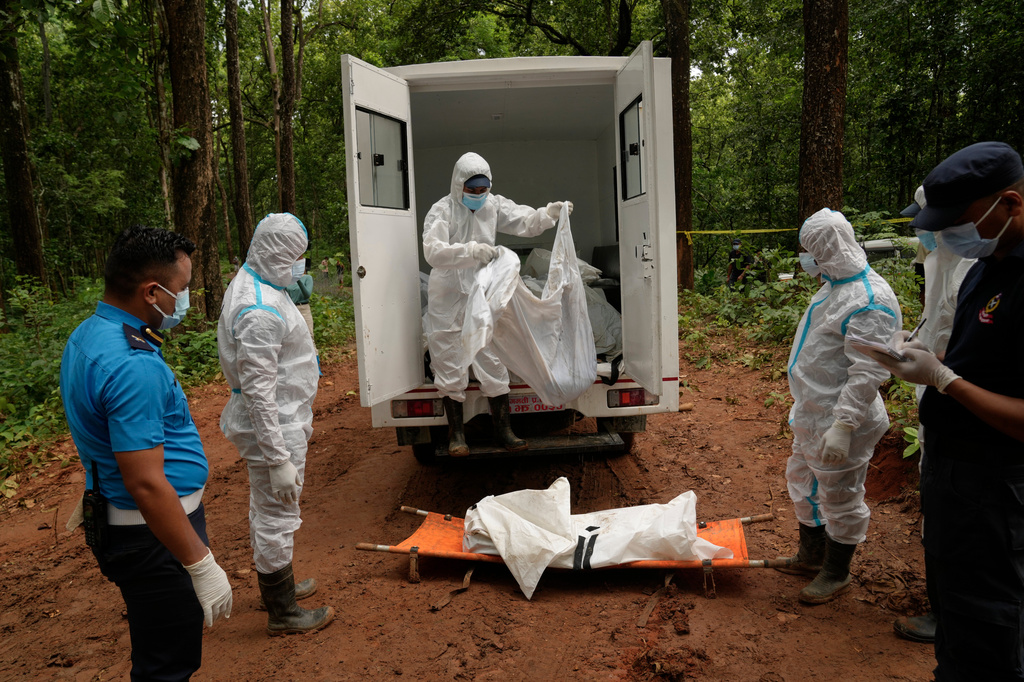 Nepal's paramilitary force personnel prepare the bodies of flash flood victims for burial at a mass burial site in Chitwan, Nepal, Monday, Aug. 31, 2026. (AP Photo/Dar Yasin)