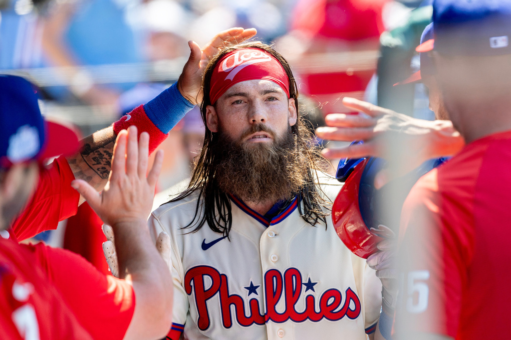 Philadelphia Phillies' Brandon Marsh is cheered in the dugout after hitting a solo home run in the third inning of a baseball game against the Chicago White Sox, Sunday, June 7, 2026, in Philadelphia. (AP Photo/Laurence Kesterson)