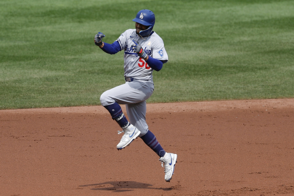Los Angeles Dodgers' Mookie Betts celebrates after his home run off Baltimore Orioles pitcher Tomoyuki Sugano as he runs the bases during the third inning of a baseball game, Sunday, Sept. 7, 2025, in Baltimore. (AP Photo/Terrance Williams)