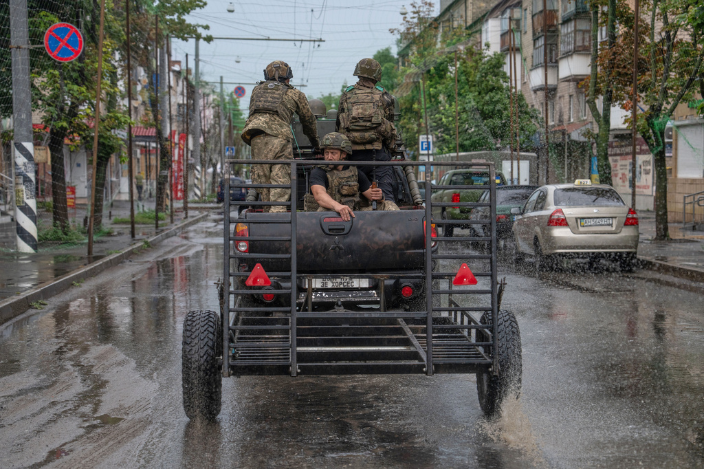 In this photo provided by Ukraine's 93rd Kholodnyi Yar Separate Mechanized Brigade press service, Ukrainian servicemen patrol a street in the frontline town of Druzhkivka, Donetsk region, Ukraine Friday, July 10, 2026. (Iryna Rybakova/Ukraine's 93rd Mechanized Brigade via AP)