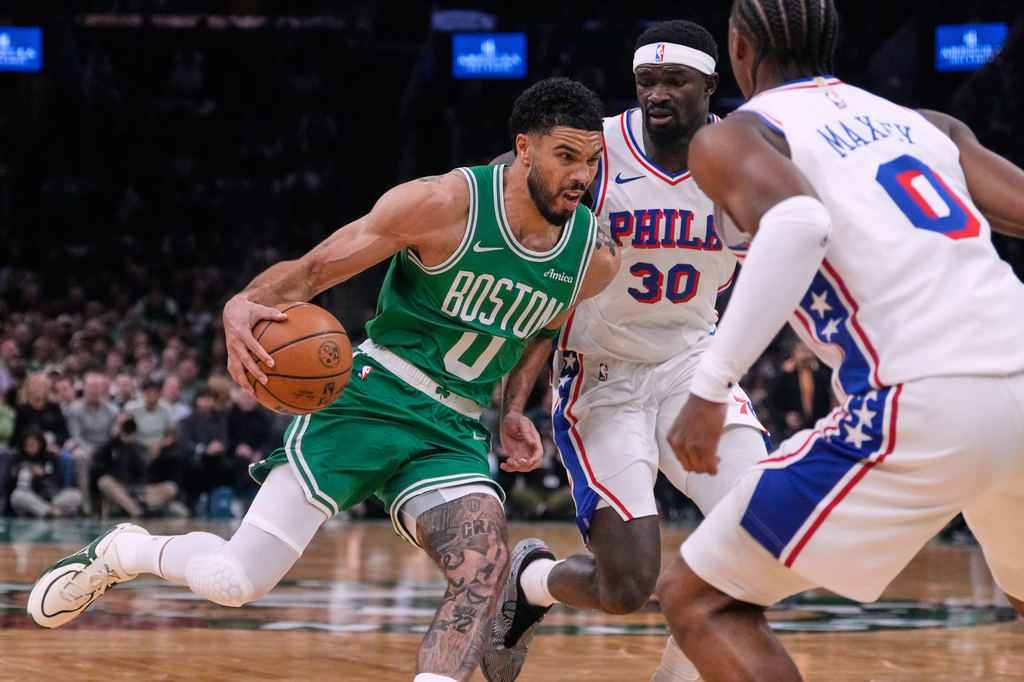 Boston Celtics forward Jayson Tatum (0) drives to the basket past Philadelphia 76ers center Adem Bona (30) during the first half of Game 2 of a first-round NBA playoffs basketball series, Tuesday, April 21, 2026, in Boston. (AP Photo/Charles Krupa)