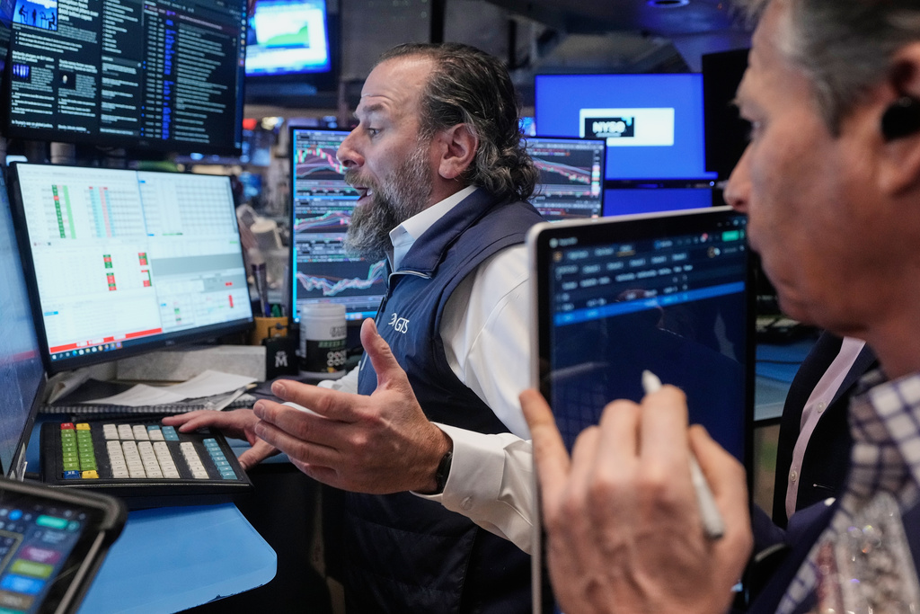 Specialist Michael Pistillo, left, and trader Robert Charmak work on the floor of the New York Stock Exchange, Friday, Feb. 6, 2026. (AP Photo/Richard Drew)