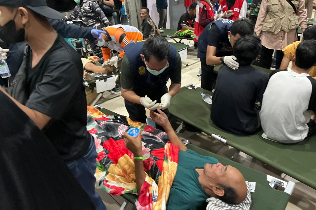 In this photo taken with a smartphone, survivors receive medical treatment after a ferry sank in bad weather in the Java Sea, at a port in Banjarmasin, South Kalimantan, Indonesia, Sunday, Sept. 13, 2026. (AP Photo/Iman Satria)