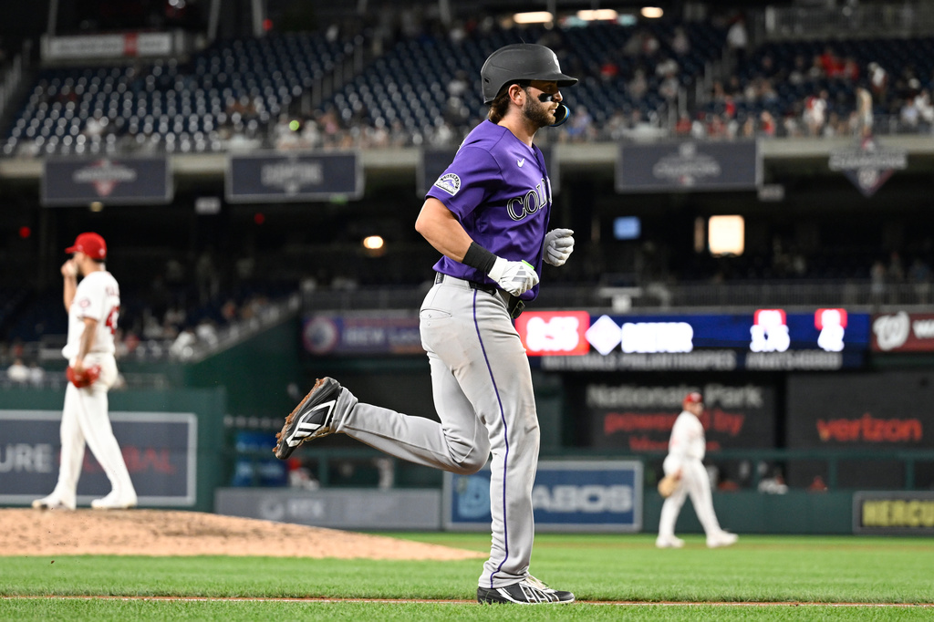 Colorado Rockies' Connor Norby runs to home plate after hitting a grand slam during the seventh inning of a baseball game against the Washington Nationals, Wednesday, Aug. 26, 2026, in Washington. (AP Photo/John McDonnell)