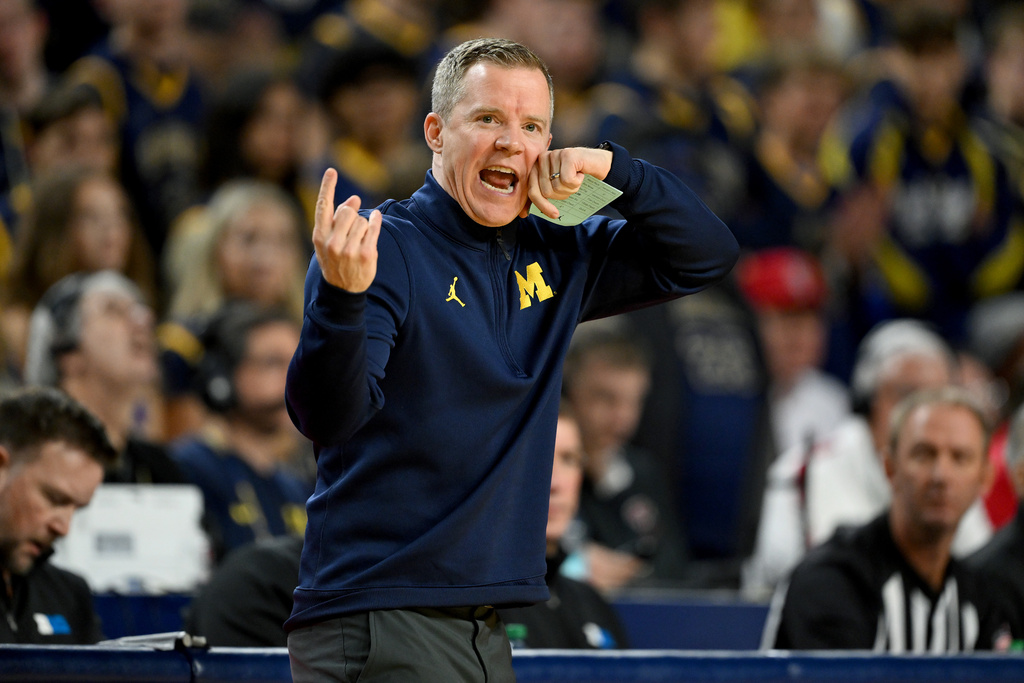 Michigan head coach Dusty May talks to his players from the bench against the Wisconsin in the first half of an NCAA college basketball game in Ann Arbor, Mich., Saturday, Jan. 10, 2026. (AP Photo/Lon Horwedel)