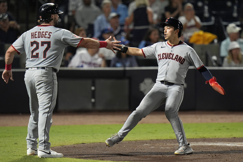 Cleveland Guardians' Austin Hedges (27) and Steven Kwan celebrate after scoring on a two-run double by José Ramírez off Tampa Bay Rays pitcher Ian Seymour during the second inning of a baseball game Friday, Sept. 5, 2025, in Tampa, Fla. (AP Photo/Chris O'Meara)