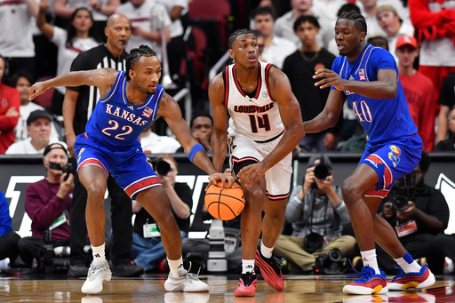 Kansas guard Darryn Peterson (22) slaps the ball away from Louisville guard Adrian Wooley (14) during the first half of an NCAA exhibition college basketball game in Louisville, Ky., Friday, Oct. 24, 2025. (AP Photo/Timothy D. Easley) Kansas guard Darryn Peterson (22) slaps the ball away from Louisville guard Adrian Wooley (14) during the first half of an NCAA exhibition college basketball game in Louisville, Ky., Friday, Oct. 24, 2025. (AP Photo/Timothy D. Easley)