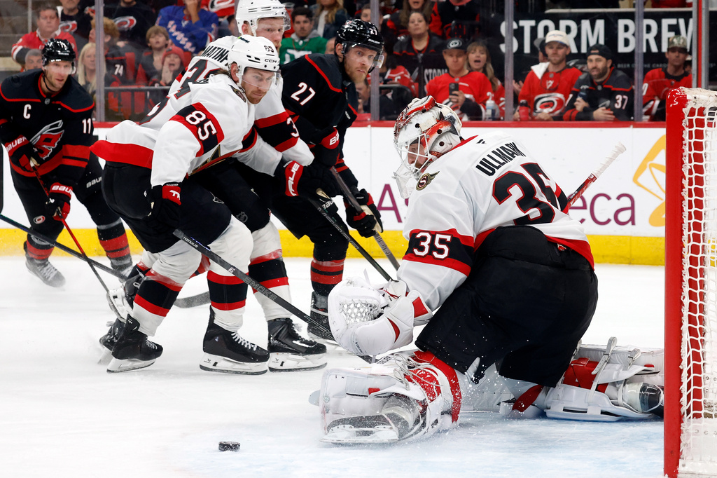 Ottawa Senators goaltender Linus Ullmark (35) has the shot of Carolina Hurricanes' Nikolaj Ehlers (27) go wide of the net with Senators' Jake Sanderson (85) nearby during the second period of Game 2 of an NHL hockey Stanley Cup first-round playoff series in Raleigh, N.C., Monday, April 20, 2026. (AP Photo/Karl DeBlaker)