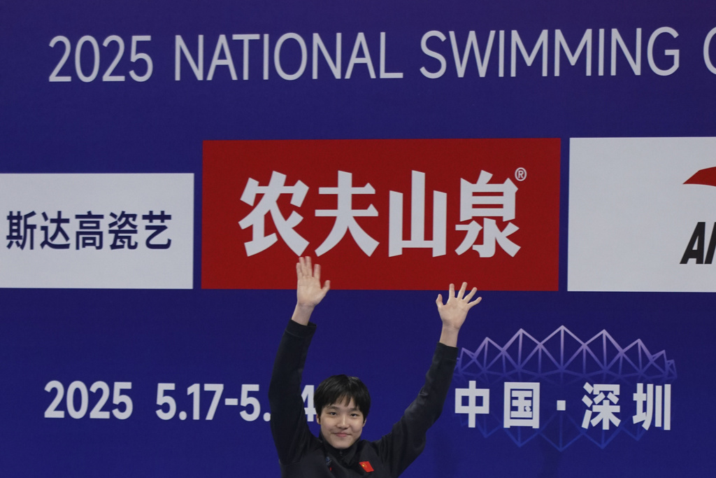 In this photo taken May 24, 2025 and released by Hebei Taihua Jinye Swimming Club, 12 years old Chinese swimmer Yu Zidi celebrates on the podium of the 2025 National Swimming Championships after competing in the Women's 400m Individual Medley event in Shenzhen in southern China's Guangdong province.(Hebei Taihua Jinye Swimming Club via AP)