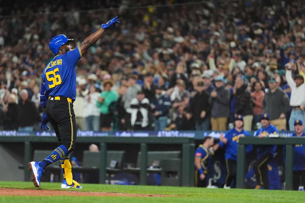 Seattle Mariners' Randy Arozarena reacts while crossing home after hitting a two-run home run against the Houston Astros during the fifth inning of a baseball game, Friday, April 10, 2026, in Seattle. (AP Photo/Lindsey Wasson)