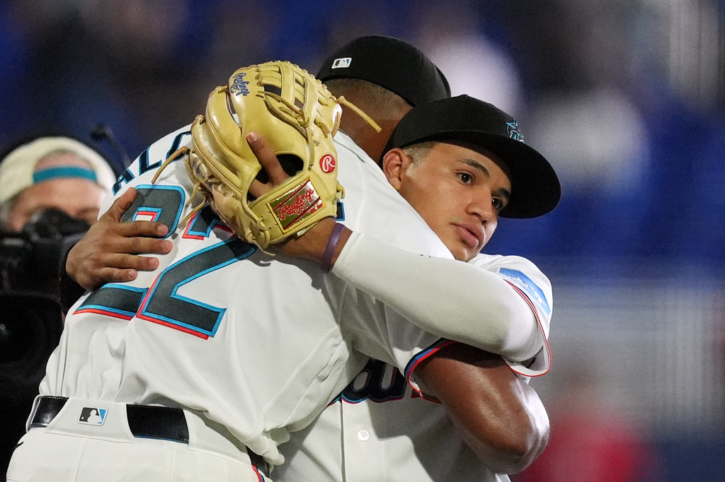 Miami Marlins third baseman Javier Sanoja, right, hugs starting pitcher Sandy Alcantara after he pitched a complete game shut out against the Chicago White Sox, Wednesday, April 1, 2026, in Miami. (AP Photo/Rebecca Blackwell)