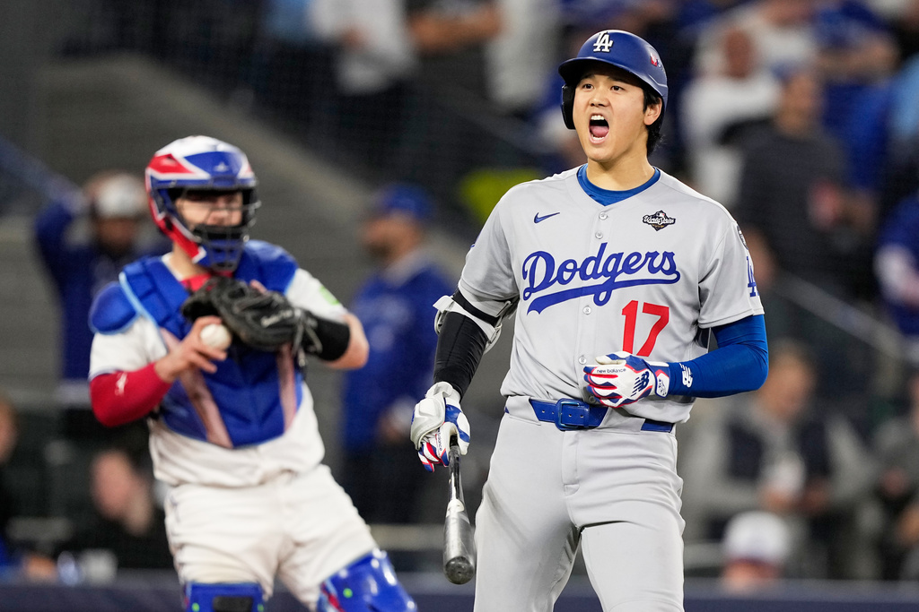 Los Angeles Dodgers' Shohei Ohtani celebrates a walk against the Toronto Blue Jays during the seventh inning in Game 7 of baseball's World Series, Saturday, Nov. 1, 2025, in Toronto. (AP Photo/Brynn Anderson)