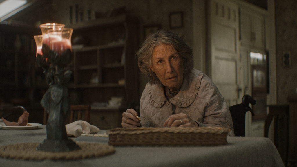 This image released by Warner Bros. Pictures shows Maude Davey in a scene from "Evil Dead Burn." (Warner Bros. Pictures via AP)