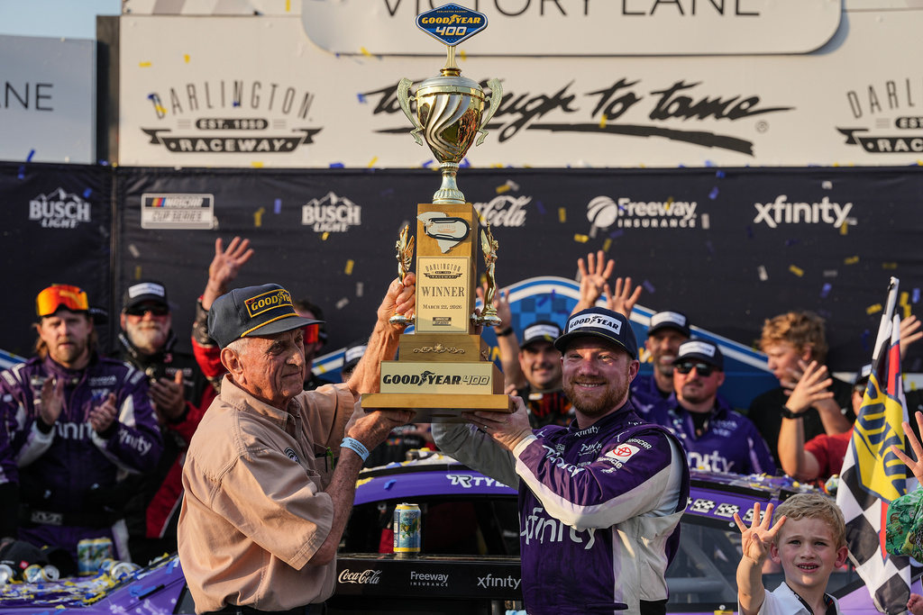 Tyler Reddick, center right, celebrates with his team in Victory Lane after winning a NASCAR Cup Series auto race, Sunday, March 22, 2026, in Darlington, S.C.(AP Photo/Matt Kelley)
