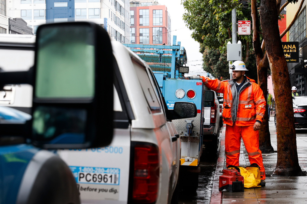 Pacific Gas & Electric crews walk around the substation building at 8th and Mission streets, in San Francisco, Monday, Dec. 22, 2025, as they work to repair infrastructure that failed and caused massive power outages across the city. (Jessica Christian/San Francisco Chronicle via AP)