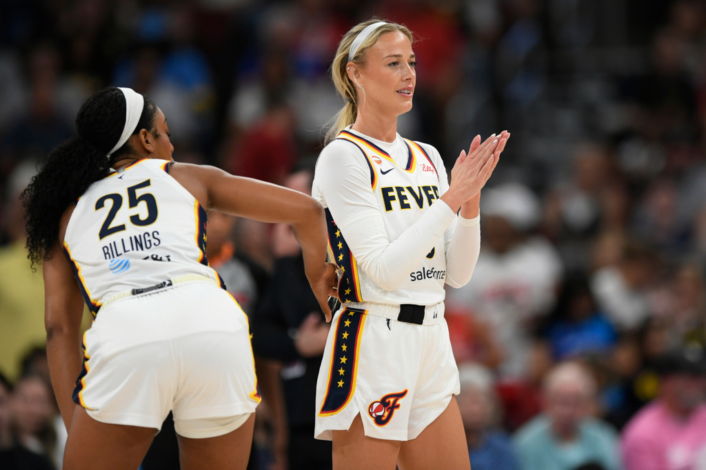 Indiana Fever's Sophie Cunningham claps as Chicago Sky's DiJonai Carrington is ejected from the game after committing a flagrant foul against her during the first half of an WNBA basketball game in Chicago, Saturday, Aug. 8, 2026. (AP Photo/Paul Beaty)