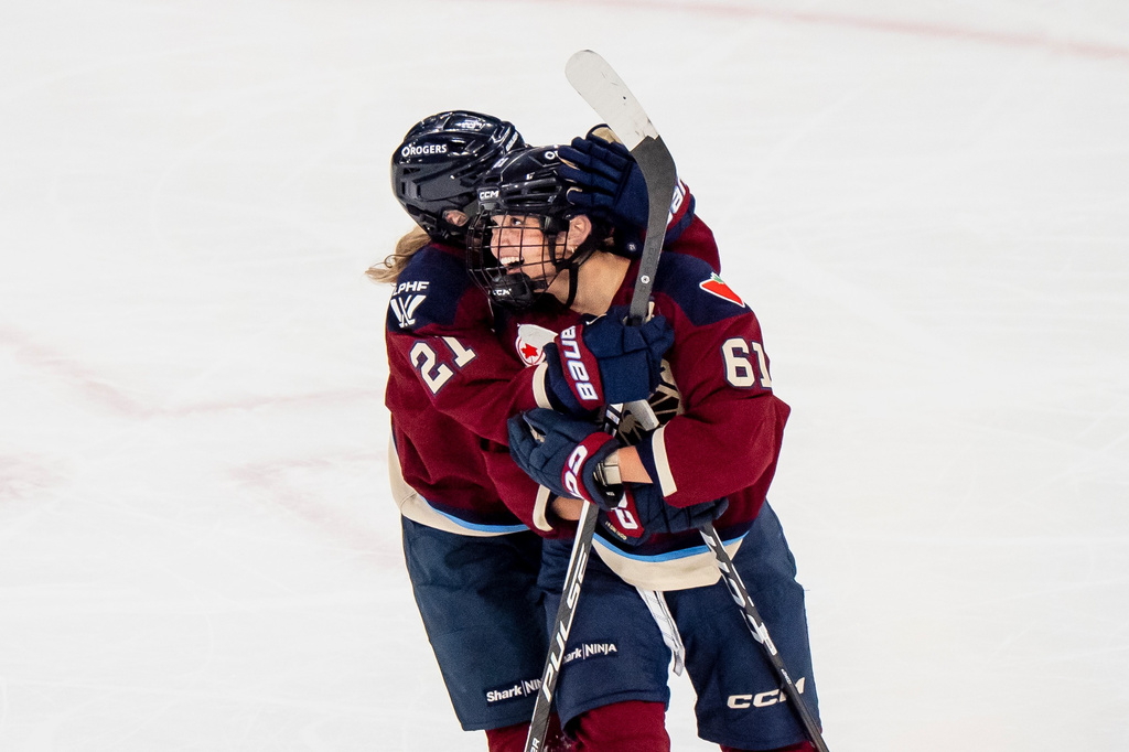 Montreal Victoire's Nicole Gosling (61) celebrates her goal against the Ottawa Charge with teammate Maureen Murphy (21) during the third period PWHL playoff hockey action in Laval, Quebec, on Thursday, May 14, 2026. (Christopher Katsarov/The Canadian Press via AP)