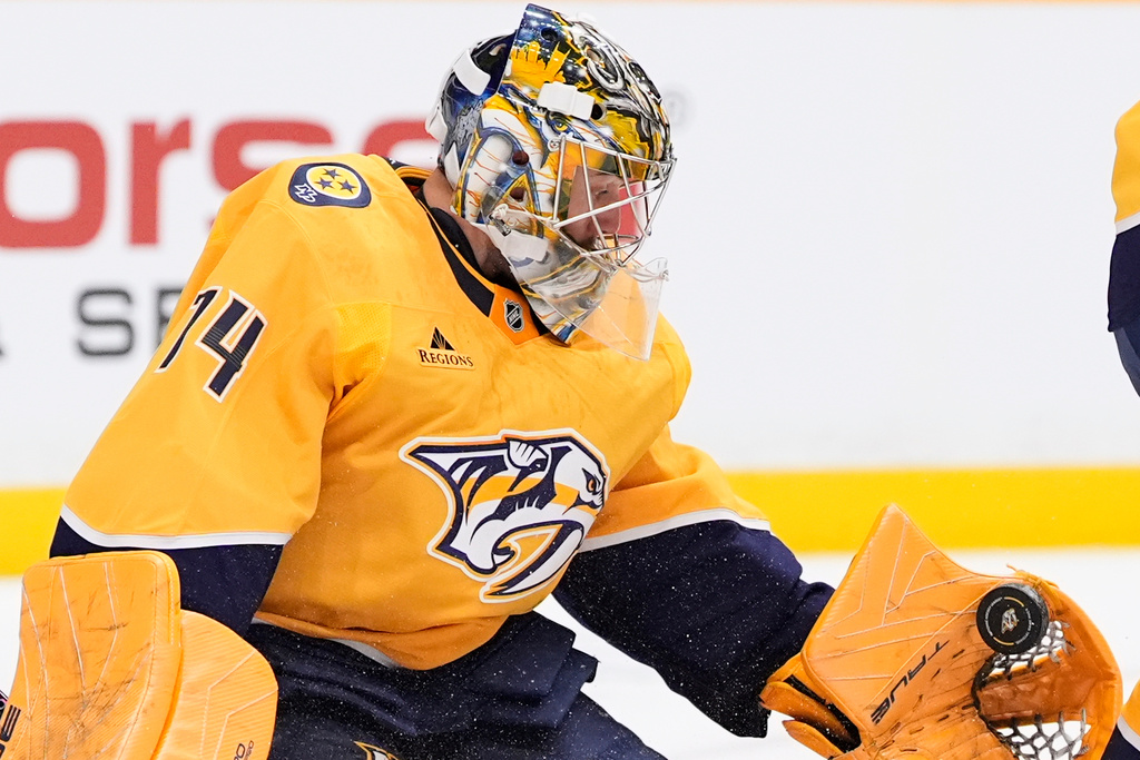 Nashville Predators goaltender Juuse Saros (74) catches a shot on goal in his glove during the first period of an NHL hockey game against the Colorado Avalanche, Tuesday, Dec. 9, 2025, in Nashville, Tenn. (AP Photo/George Walker IV)