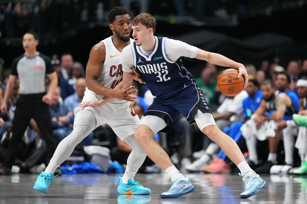 Dallas Mavericks forward Cooper Flagg (32) works against Cleveland Cavaliers guard Donovan Mitchell during the second half of an NBA basketball game Friday, March 13, 2026, in Dallas. (AP Photo/Julio Cortez)