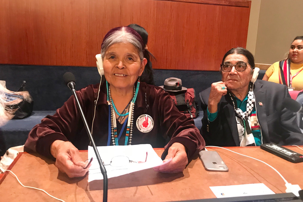 Jean Whitehorse testifies about forced and coerced sterilization of Native American women at the United Nations Permanent Forum on Indigenous Issues on April 2019, as Anthony Gonzales, right, executive director of the American Indian Movement listens. (Keely Badger via AP)
