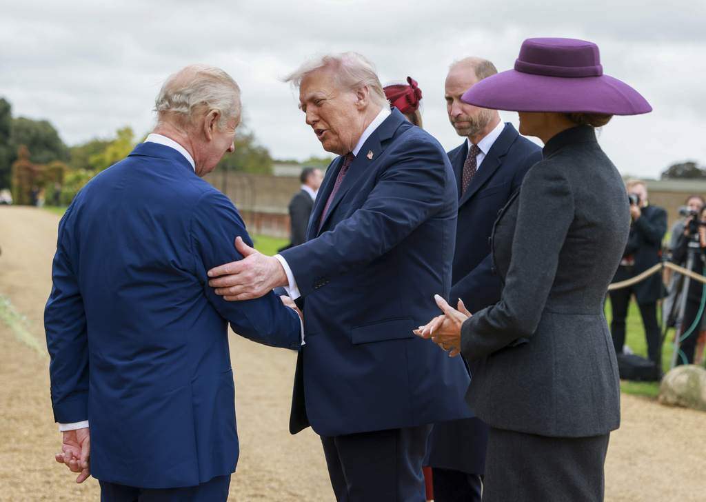 President Donald Trump and first lady Melania Trump are welcomed by Britain's King Charles III, in the Walled Garden on the Windsor Castle estate, in Windsor, England, Wednesday, Sept. 17, 2025. (Ian Vogler/Pool Photo via AP)