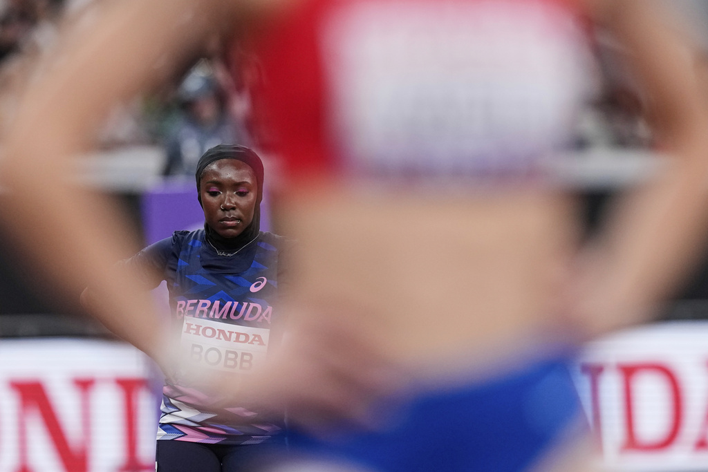 Bermuda's Caitlyn Bobb, left, prepares to compete in the women's 400 meters heat at the World Athletics Championships in Tokyo, Sunday, Sept. 14, 2025. (AP Photo/Eugene Hoshiko)