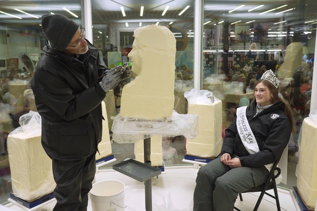 Sculptor Gerry Kulzer carves the likeness of Malorie Thorson, this year's Princess Kay of the Milky Way, out of a block of butter at the Minnesota State Fair, Thursday, Aug. 21, 2025 in Falcon Heights, Minn. (AP Photo/Mark Vancleave)