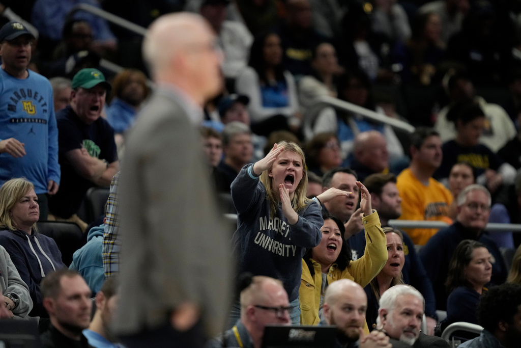 Fans cheer towards UConn head coach Dan Hurley during the second half of an NCAA college basketball game between Marquette and UConn, Saturday, March 7, 2026, in Milwaukee. (AP Photo/Aaron Gash)