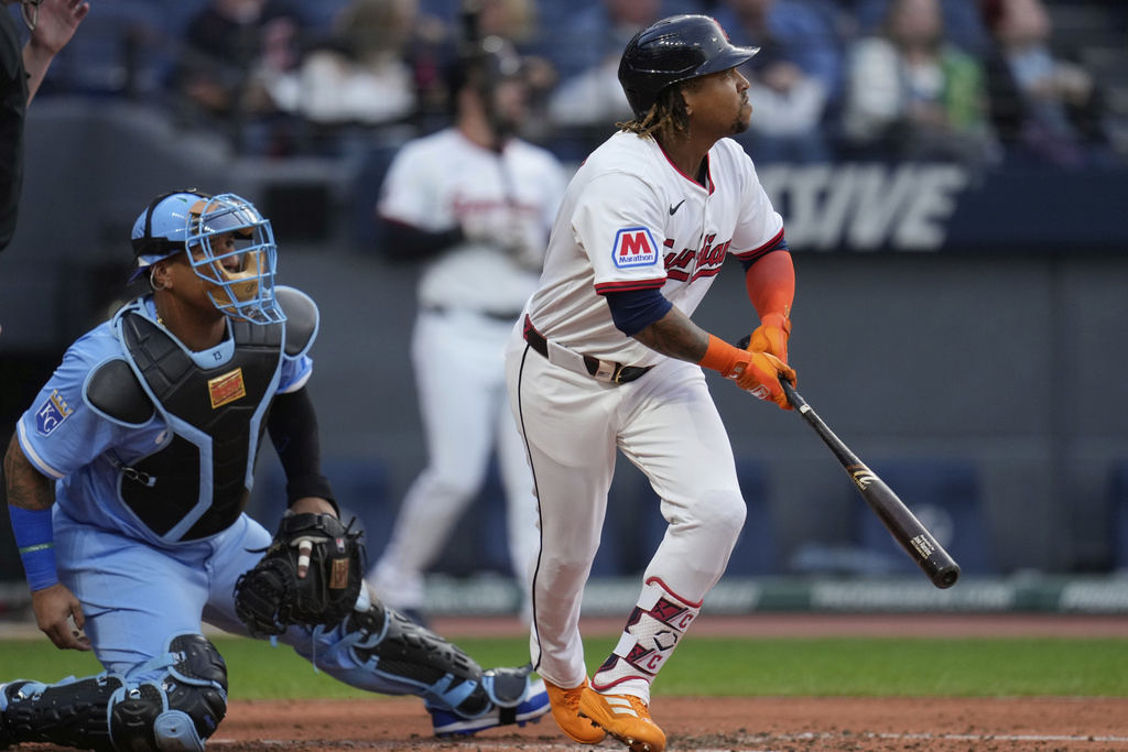 Cleveland Guardians' Jose Ramirez, right, and Kansas City Royals catcher Salvador Perez watch Ramirez's home run in the first inning of a baseball game in Cleveland, Tuesday, Sept. 9, 2025. (AP Photo/Sue Ogrocki)