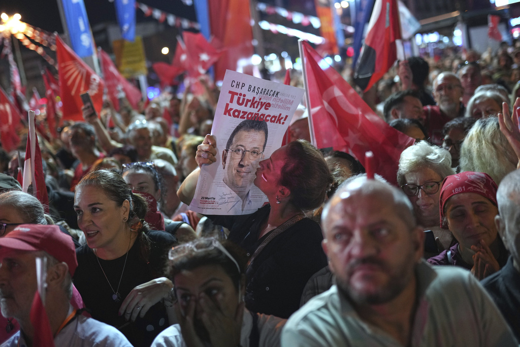 A supporter of Turkey's main opposition Republican People's Party or (CHP) kisses a image of former Istanbul Mayor Ekrem İmamoglu during a party rally, in Istanbul, Turkey, Wednesday, Sept. 10, 2025. (AP Photo/Francisco Seco)