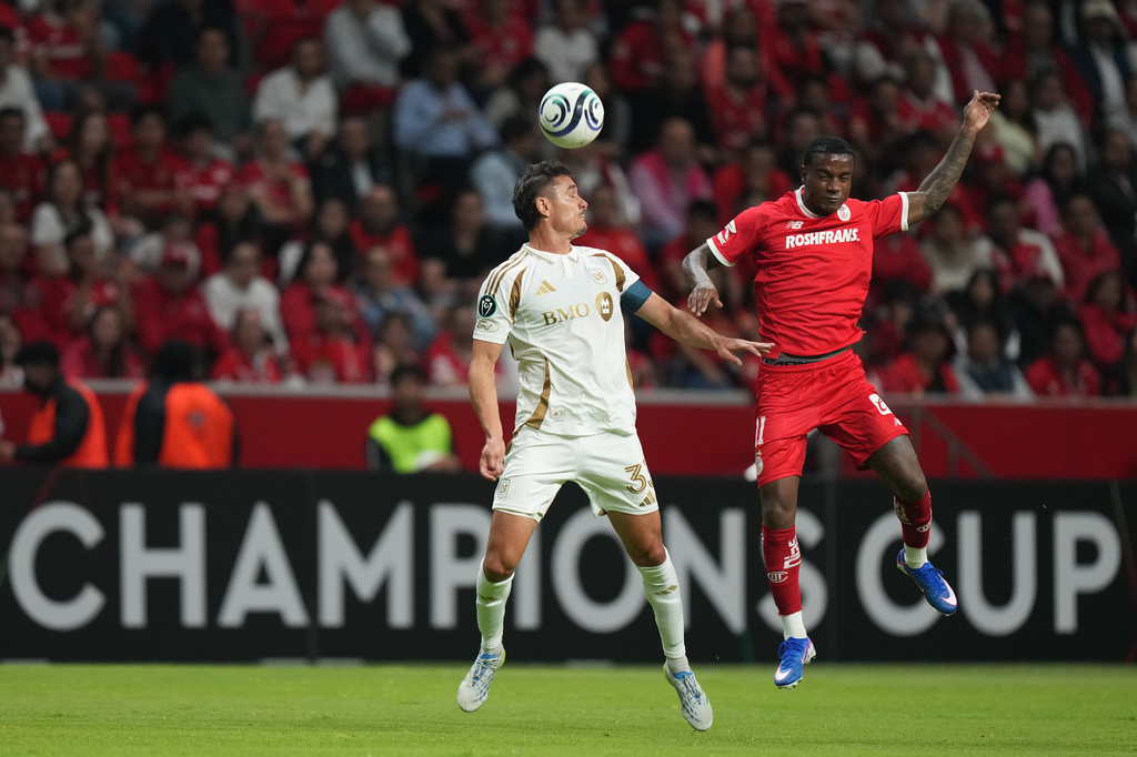 Aaron Long of the United States' Los Angeles FC, left, heads the ball past Helinho of Mexico's Toluca during a CONCACAF Champions Cup second leg semifinal soccer match in Toluca, Mexico, Wednesday, May 6, 2026. (AP Photo/Fernando Llano)