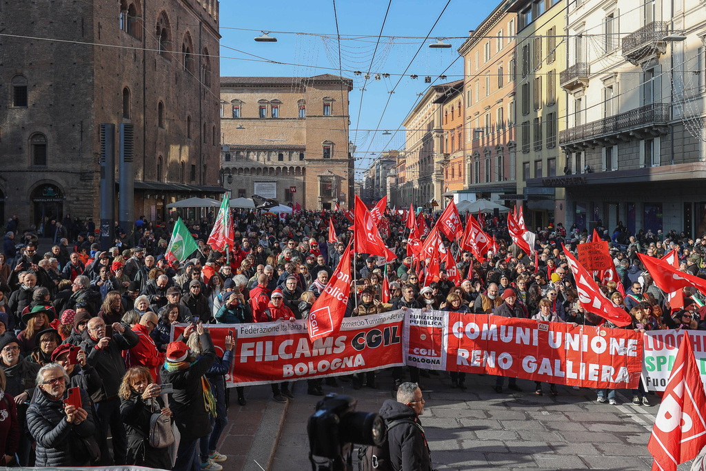 People gather on the occasion of a general strike called by the CGIL (Italian General Confederation of Labour) trade union to protest against the budget law in Bologna, Italy, Friday, Dec. 12, 2025. (Guido Calamosca/LaPresse via AP)