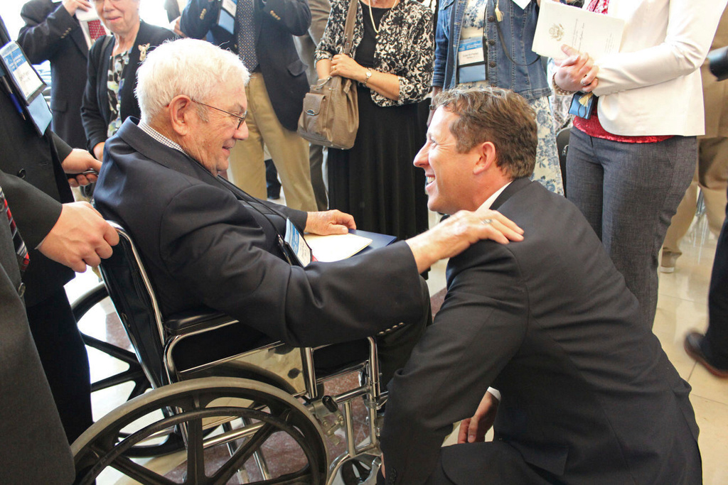 Rep. Adrian Smith greets Congressional Gold Medal recipient Donald McPherson of Adams at the ceremonies in 2015. (Beatrice Daily Sun via AP)