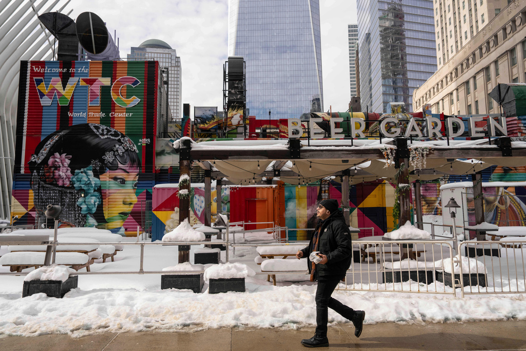 A person walks past 2 World Trade Center where American Express will build new global headquarters, Wednesday, Feb. 25, 2026, in New York. (AP Photo/Yuki Iwamura)