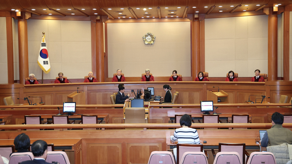 Kim Sang-hwan, top center, chief justice of the Constitutional Court and the court's other justices attend a hearing to deliver a verdict on impeached police chief Cho Ji-ho at the court in Seoul, South Korea, Thursday, Dec. 18, 2025. (Kim Sung-min/Yonhap via AP)
