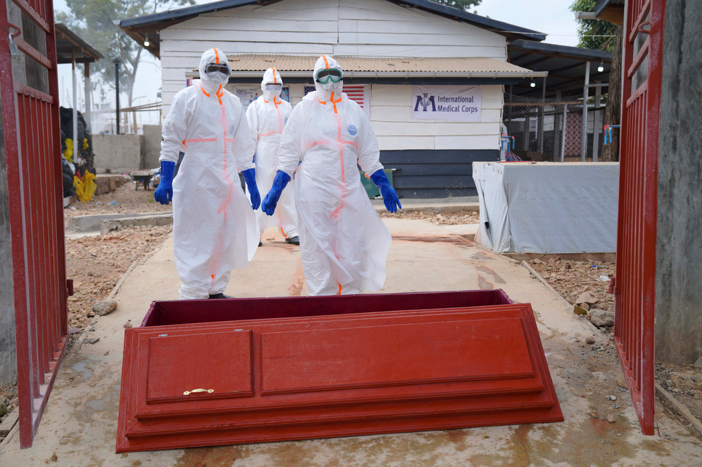 Health workers who are members of the safe and dignified burial team prepare to bury Abineno Justine, a 38 year old woman who died of the Ebola virus, in Bunia, Congo, Friday, Sept. 4, 2026. (AP Photo/Dieudonne Dirole)