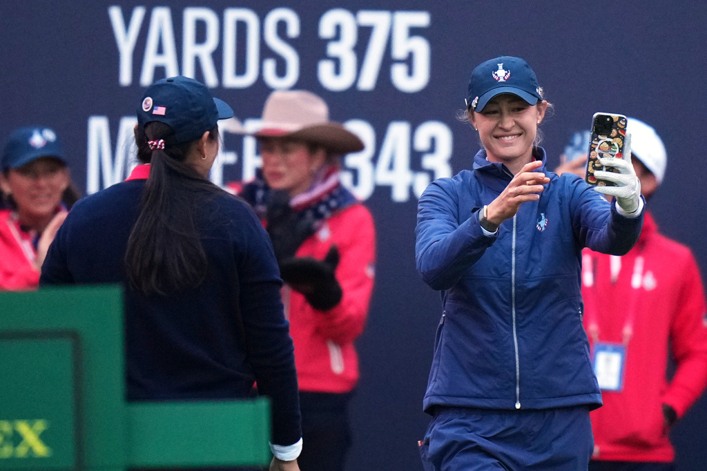 Nelly Korda, right, of the United States stakes a selfie on the first tee as teammate Allisen Corpuz watches during the Solheim Cup at the Bernardus Golf course in Den Bosch, Netherlands, Friday, Sept. 11, 2026. (AP Photo/Alastair Grant)
