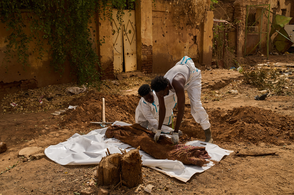 Members of the Forensic Medicine Corporation team exhume the body of Mohammed Alsawi, 73, who was killed in 2023 by the paramilitary group Rapid Support Forces, or RSF, in Omdurman, on the outskirts of Khartoum, Sudan, Monday, April 20, 2026. (AP Photo/Bernat Armangue)