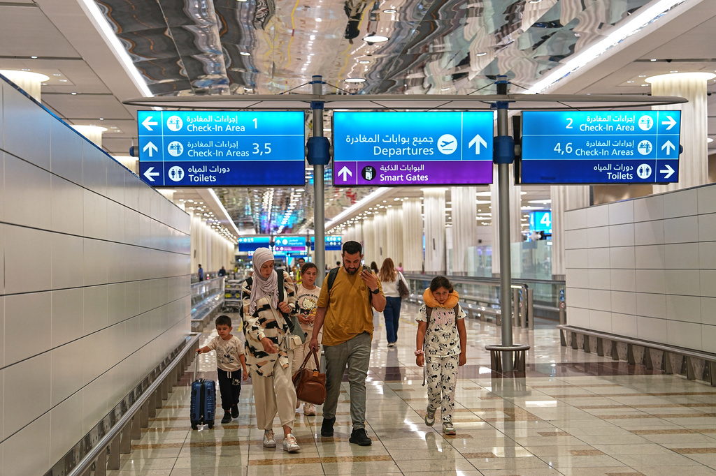 A family walks through Terminal 3 at Dubai International Airport in Dubai, United Arab Emirates, Wednesday, Aug. 26, 2026. (AP Photo/ Fatima Shbair)