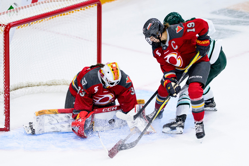 Ottawa Charge goaltender Gwyneth Philips (33) makes a pad save on a shot by Boston Fleet's Theresa Schafzahl (17) during overtime in a PWHL hockey game in Ottawa, Ontario, on Saturday, Dec. 27, 2025. (Spencer Colby/The Canadian Press via AP)