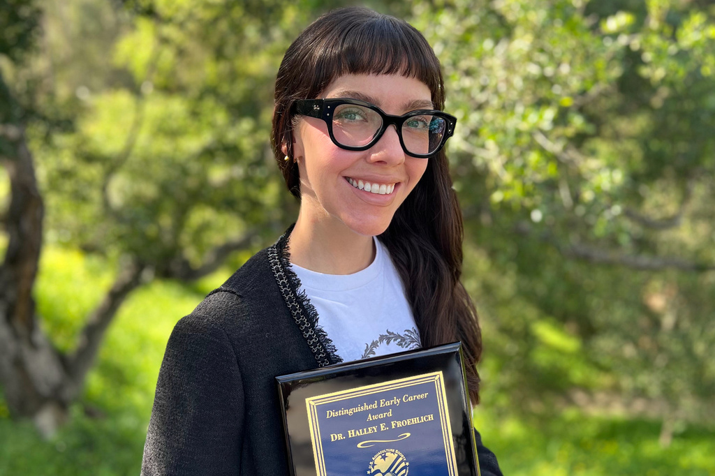 This photo taken with a smart phone and provided by Halley Froehlich shows Froehlich holding a U.S. Aquaculture Society award in Santa Barbara, Calif., on Feb. 27, 2026. (Halley Froehlich via AP)