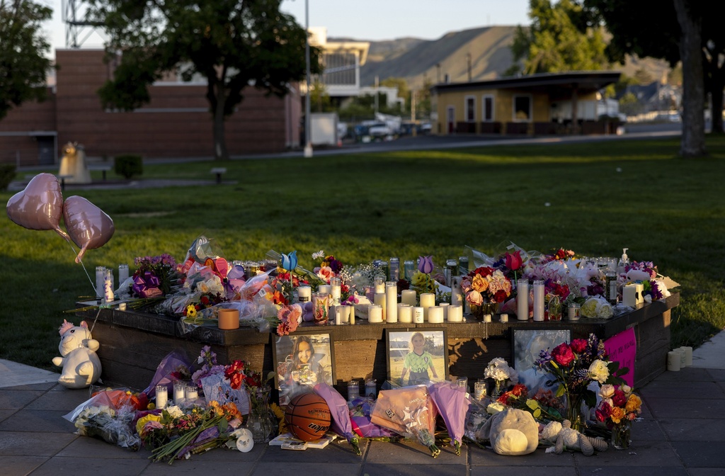 FILE - Pictures, flowers and candles mark a makeshift memorial Tuesday, June 3, 2025, in Wenatchee, Wash., in honor of Olivia, Paityn and Evelyn Decker, who were found dead near Leavenworth after their father Travis Decker failed to return them after a scheduled visitation. (Nick Wagner/The Seattle Times via AP,File)