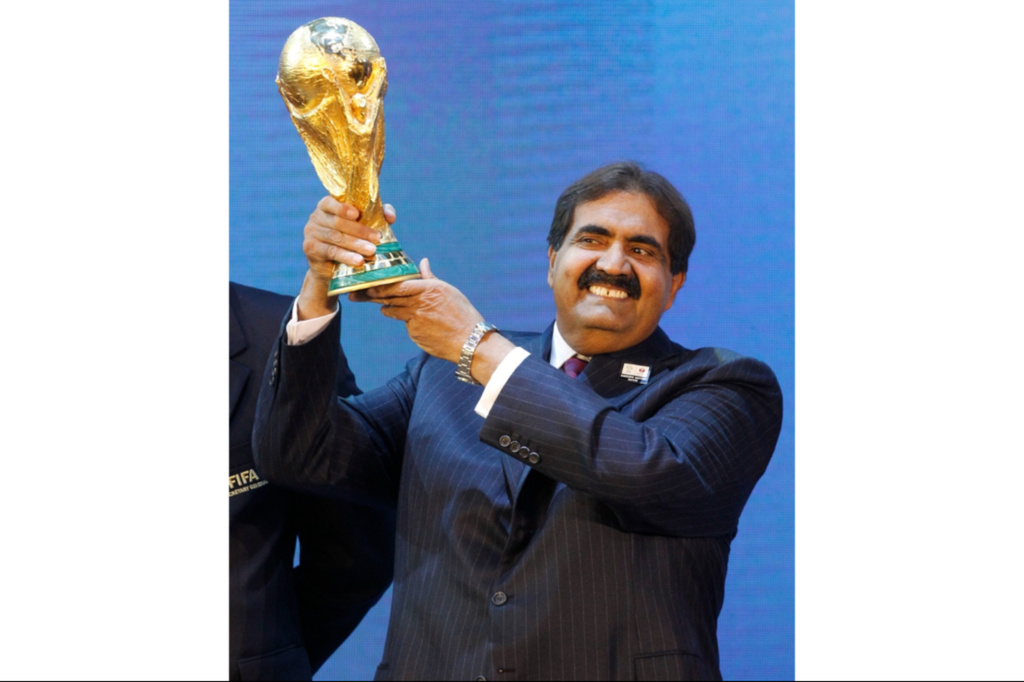 FILE - Sheikh Hamad bin Khalifa Al Thani, Emir of Qatar, holds the World Cup trophy after the announcement of Qatar hosting the 2022 soccer World Cup in Zurich, Switzerland, Dec. 2, 2010. (AP Photo/Anja Niedringhaus, File)