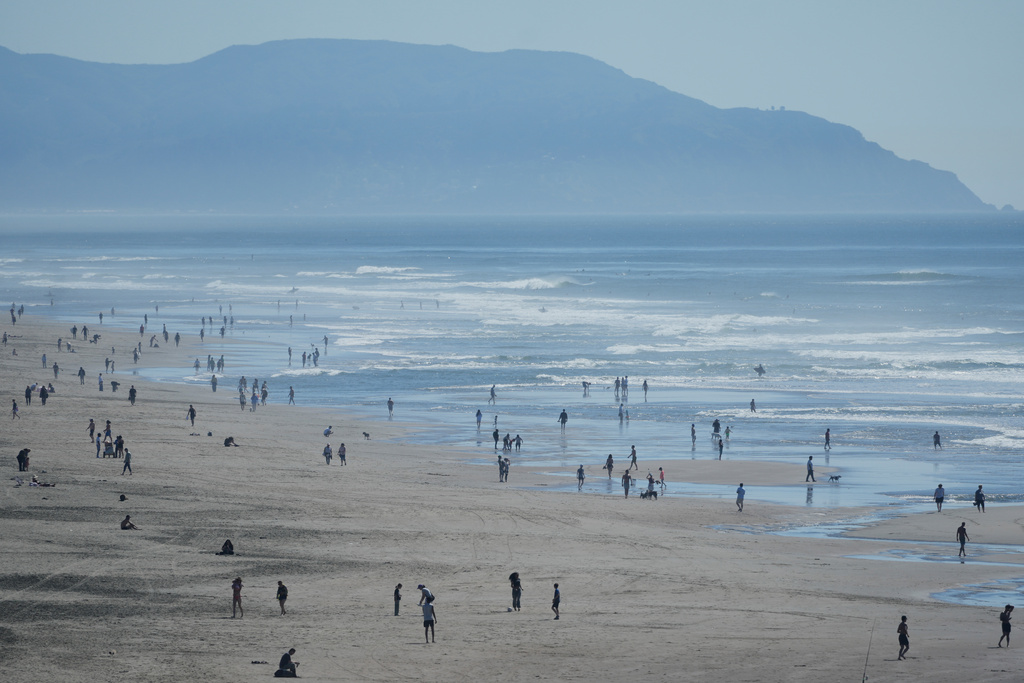 People visit Ocean Beach in San Francisco, Tuesday, March 17, 2026. (AP Photo/Jeff Chiu)