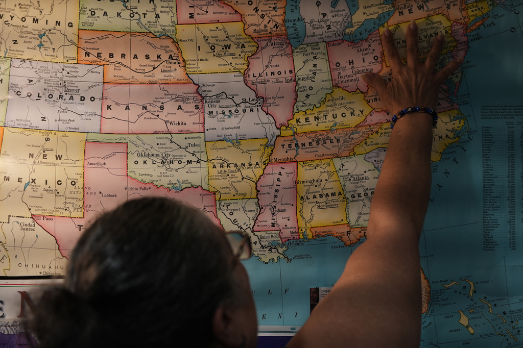 Leila Borrero Krouse, an immigration specialist with CATA, a nonprofit supporting farmworkers throughout the Eastern Shore, points to a U.S. map in her office to explain how many migrants come to the region to work as farmworkers, caregivers and in the poultry plants, in Salisbury, Md., Saturday, Aug. 1, 2026. (AP Photo/Luis Andres Henao)