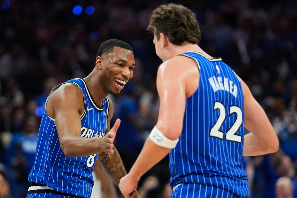 Orlando Magic forward Jamal Cain, left, celebrates a big play against the Charlotte Hornets with forward Franz Wagner (22) during the second half of an NBA play-in tournament basketball game, Friday, April 17, 2026, in Orlando, Fla. (AP Photo/John Raoux)