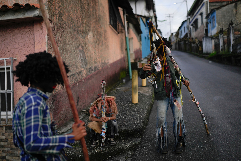 Revelers take part in the Afro-Venezuelan Holy Innocents' Day celebration in Caucagua, Venezuela, Sunday, Dec. 28, 2025. (AP Photo/Matias Delacroix)